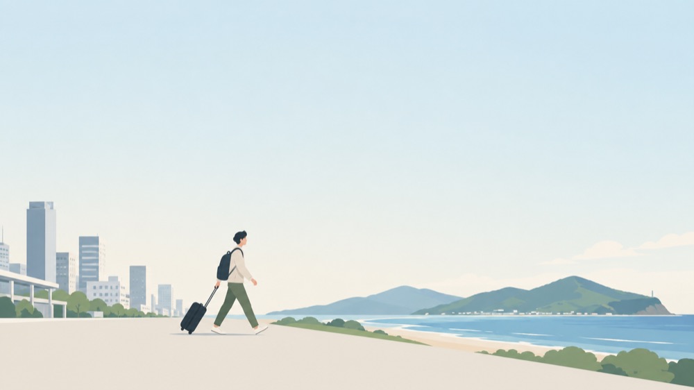 荷物を引いて歩く人。街をあとにして、海と山のある土地へ向かっている